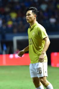 Young man playing soccer on field