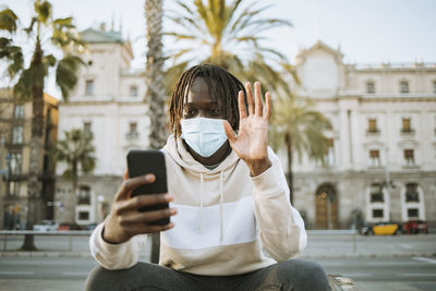 Man using mobile phone in city
