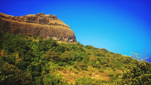 Scenic view of mountain against clear blue sky