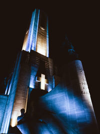 Low angle view of illuminated building against blue sky