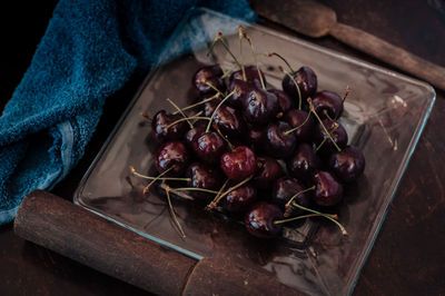 Fresh cherry on clear plate on wooden background. fresh ripe cherries. sweet cherries.