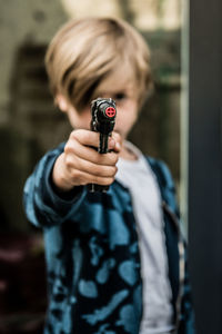 Close-up of boy holding gun