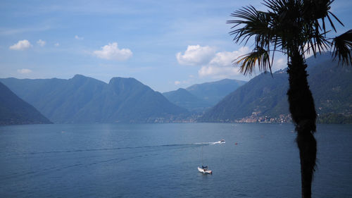 Scenic view of sea and mountains against sky