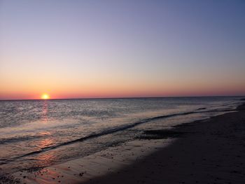 Scenic view of sea against clear sky during sunset