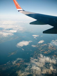 Aerial view of airplane wing over landscape