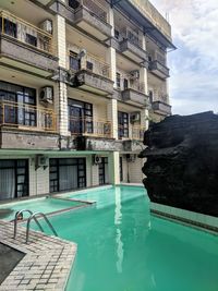 Reflection of buildings in swimming pool