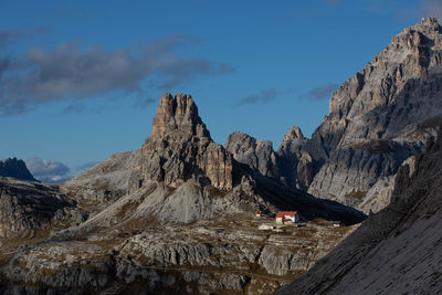 View of birds perching on rock against sky