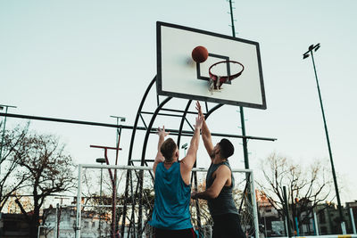 Young man playing with basketball