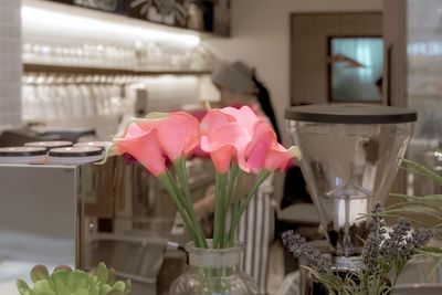 Close-up of pink flower vase on table at home