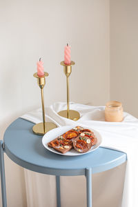 Close-up of cake served on table against wall