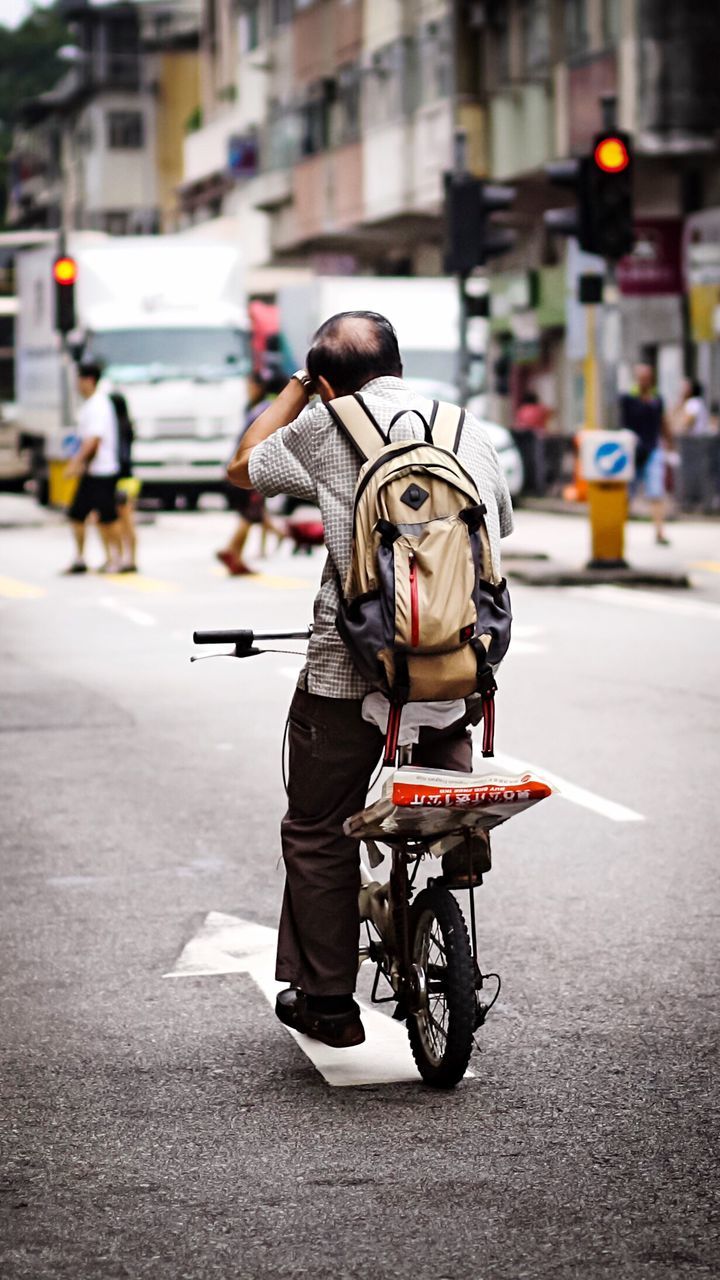 street, real people, city, motorcycle, outdoors, men, one person, adults only, adult, people, day, responsibility, headwear, one man only