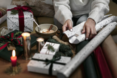 Womans hands wrapping christmas gift