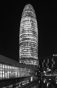 Low angle view of illuminated buildings against sky at night