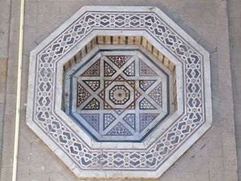 Close-up of ornate window on tiled wall of building