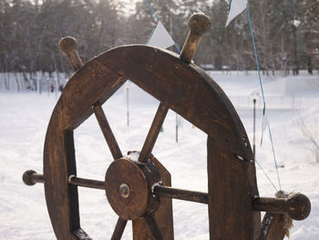 Close-up of rusty wheel on field during winter