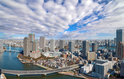 Wide angle aerial panorama of sumida river in tokyo under dramatic cloudy sky