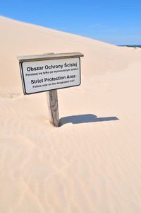 Information sign on sand dune