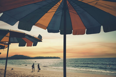 Scenic view of beach against sky during sunset