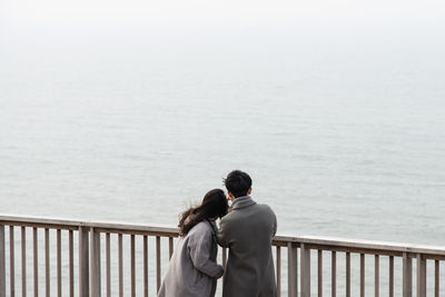 Rear view of couple looking at sea