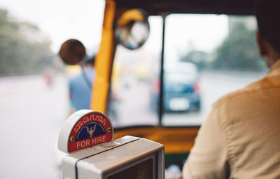 Close-up of man using mobile phone in bus