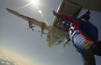 Man flying airplane against sky