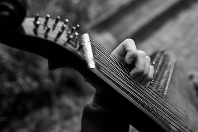 Cropped hand playing guitar