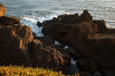 Rocks on shore by sea