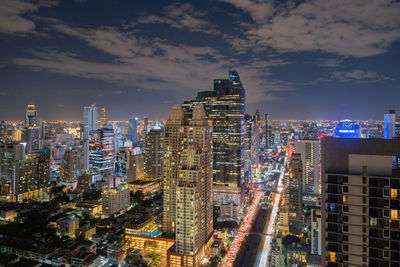 High angle view of illuminated buildings against sky in city