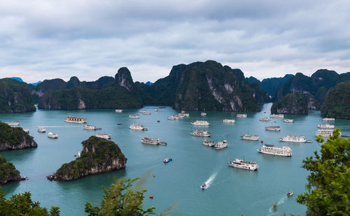 Scenic view of sea and mountains against sky