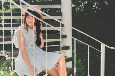 Young woman sitting on steps