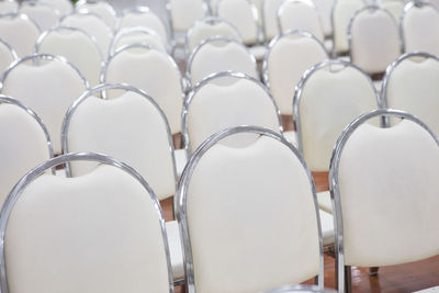 Close-up of empty chairs in row