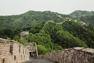 Great wall of china by trees against sky