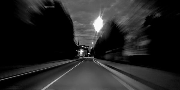 Blurred motion of road seen through car window at night