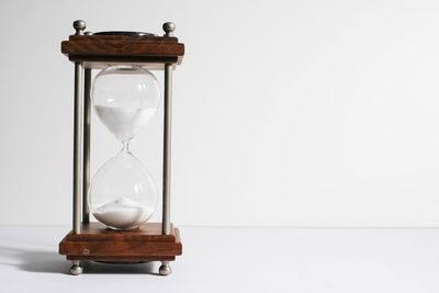 Close-up of clock on glass against white background