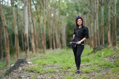 Full length portrait of woman in forest