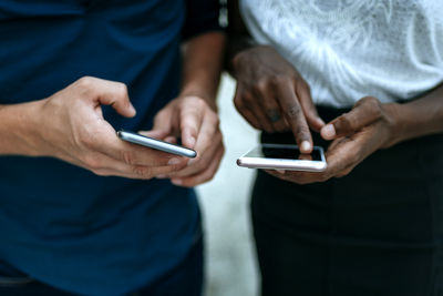 Close-up of couple using smartphone