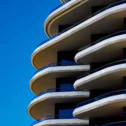 Low angle view of building against clear blue sky