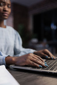 Young woman using laptop on table