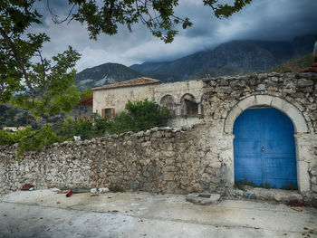 Exterior of old building by mountains against sky