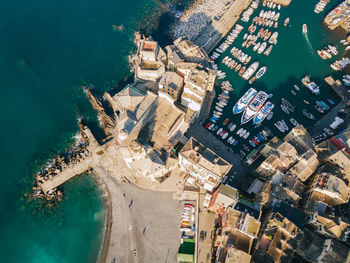 High angle view of buildings and sea in city