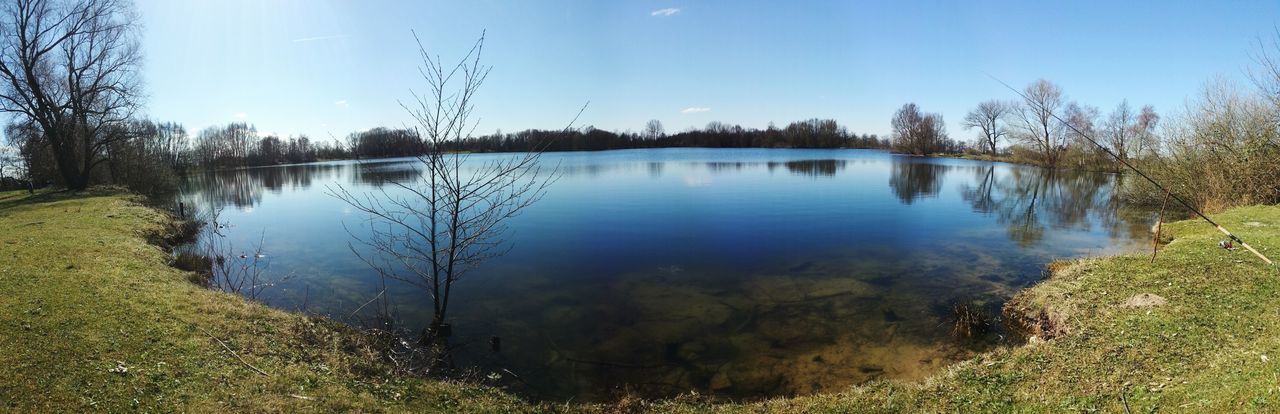 water, reflection, lake, tranquility, tranquil scene, tree, scenics, beauty in nature, nature, grass, blue, sky, clear sky, growth, idyllic, plant, standing water, calm, non-urban scene, sunlight