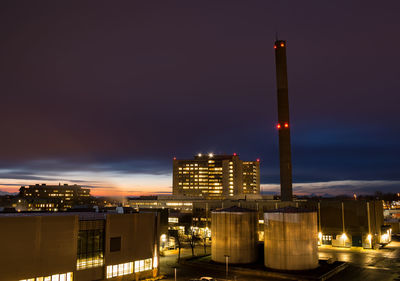 Illuminated city against sky at night