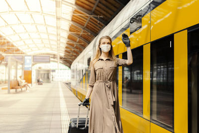 Woman standing on railroad station platform