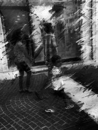 Blurred motion of man walking on cobblestone