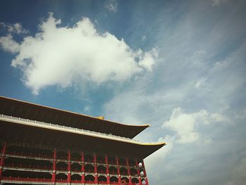 Low angle view of building against cloudy sky