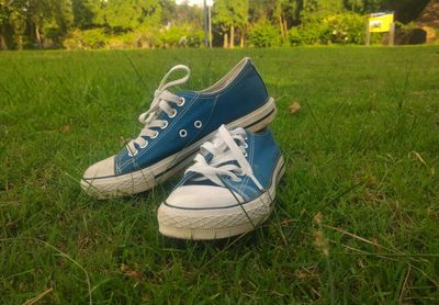 Close-up of shoes on field