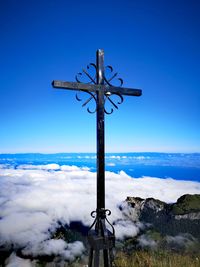 Mountain cross against blue sky