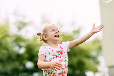 A happy laughing baby is running around the park or garden. summer, summer time, happy days