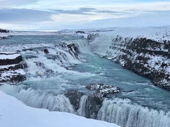 Scenic view of frozen lake against sky