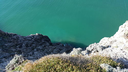 High angle view of rocks by sea